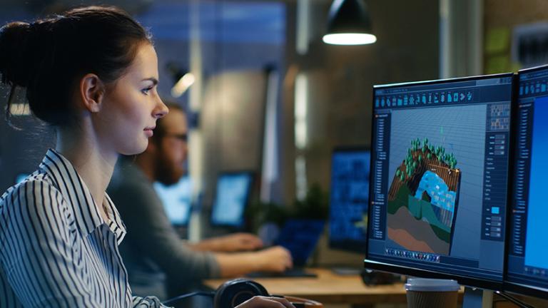 game design and interactivity professional working on computer