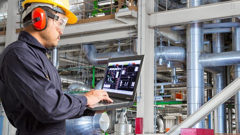power systems engineer working on laptop