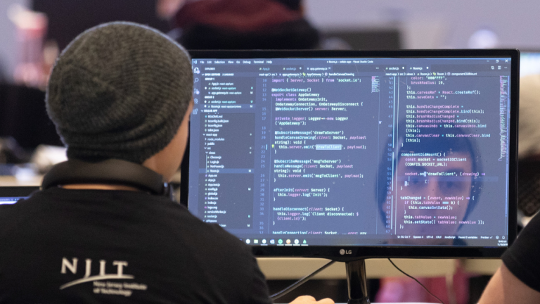 NJIT student on computer, coding