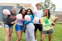 Group of diverse college students outside holding cotton candy