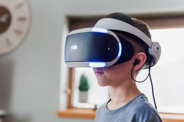 child with a virtual reality headset over his eye on head